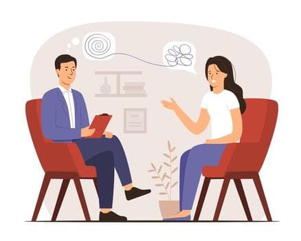 A counsellor and a student talking, seated in armchairs.